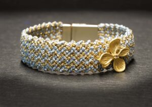 Woven macrame bracelet flower baby blue/gold
